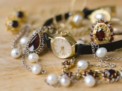 Old and retro-styled jewelry around a gold watch.